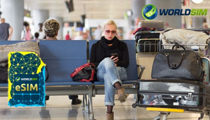 A woman in the airport waiting area using her phone